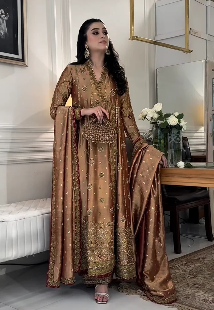 Haris Shakeel Aswad Pakistani fashion outfit in gold tones.